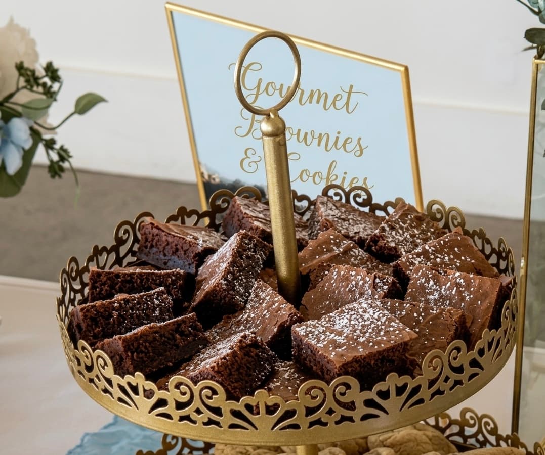 Chocolate brownies arranged on a gold dessert stand