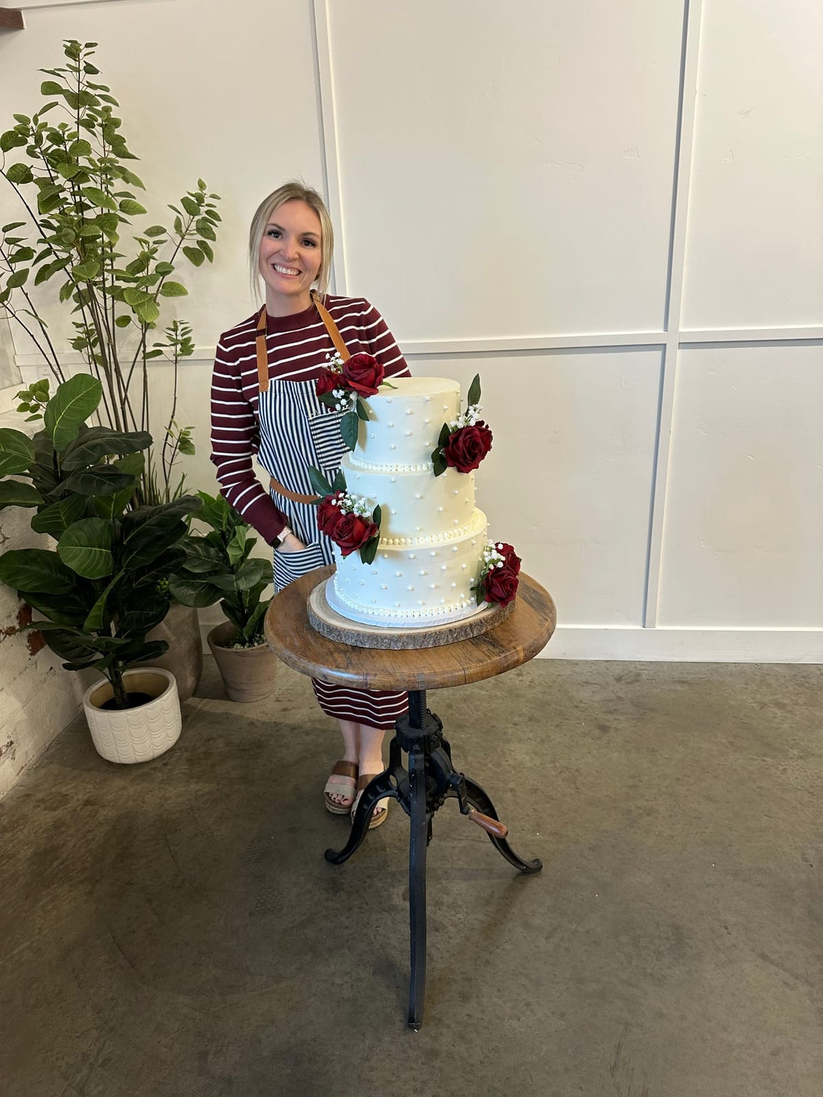 Jessica, the baker behind Baker Haven, posing proudly with one of her wedding cakes