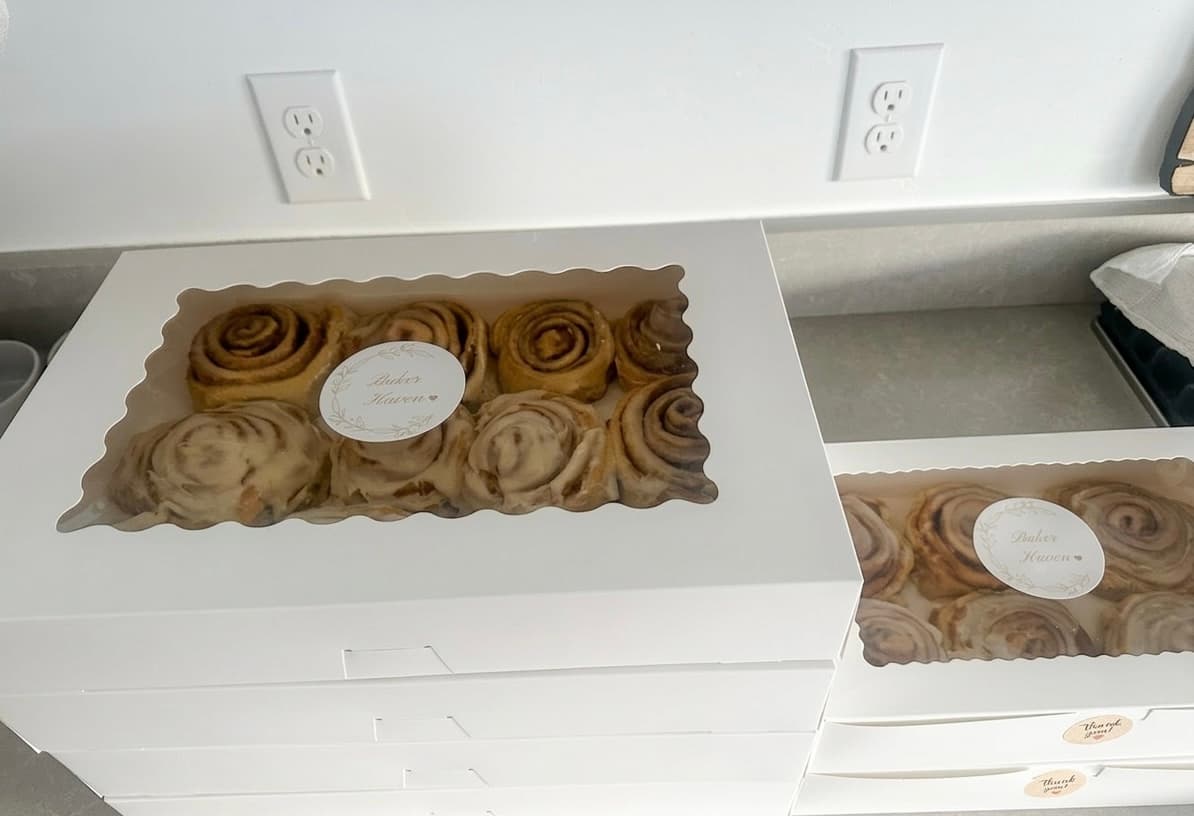 Fresh cinnamon rolls in Baker Haven branded boxes